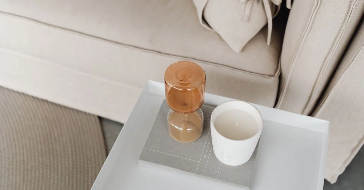 Salon élégant avec une table d'appoint présentant un sablier et une bougie.