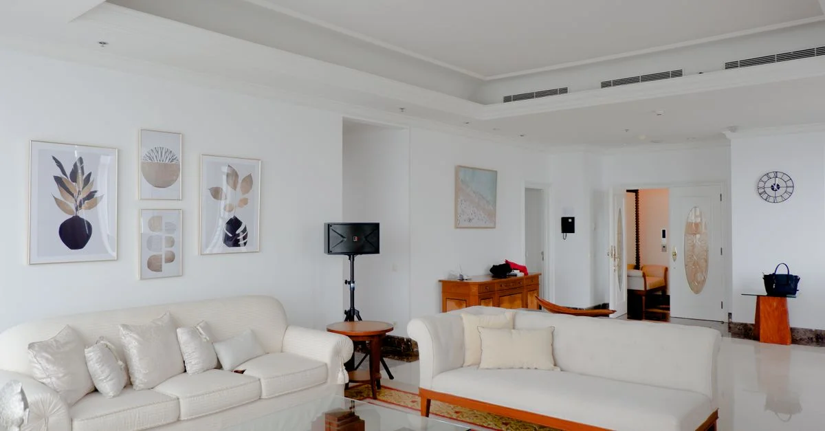 Salon sophistiqué avec des canapés blancs et une décoration moderne pour une ambiance élégante à la maison.